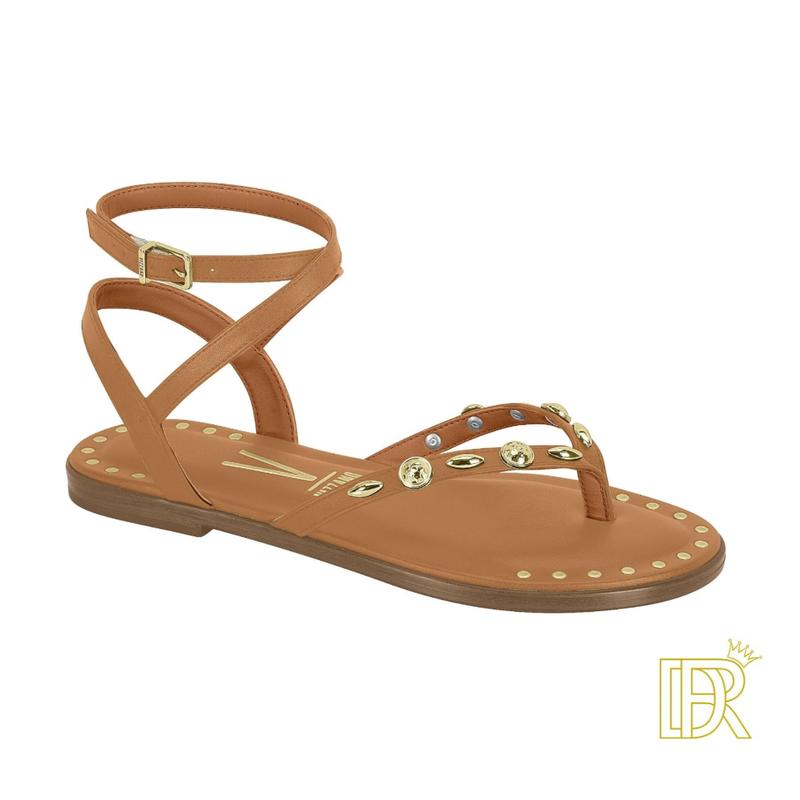 Sandals tied to the leg with golden details that give them an elegant touch